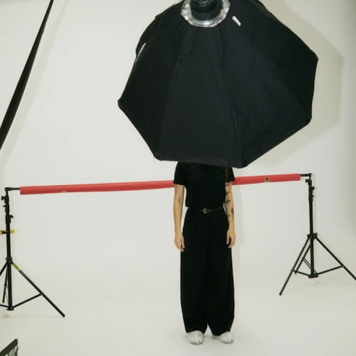A person standing under a softbox